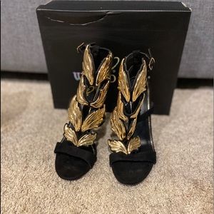 Winged gold and black heels